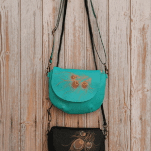 Round leather bag with feather